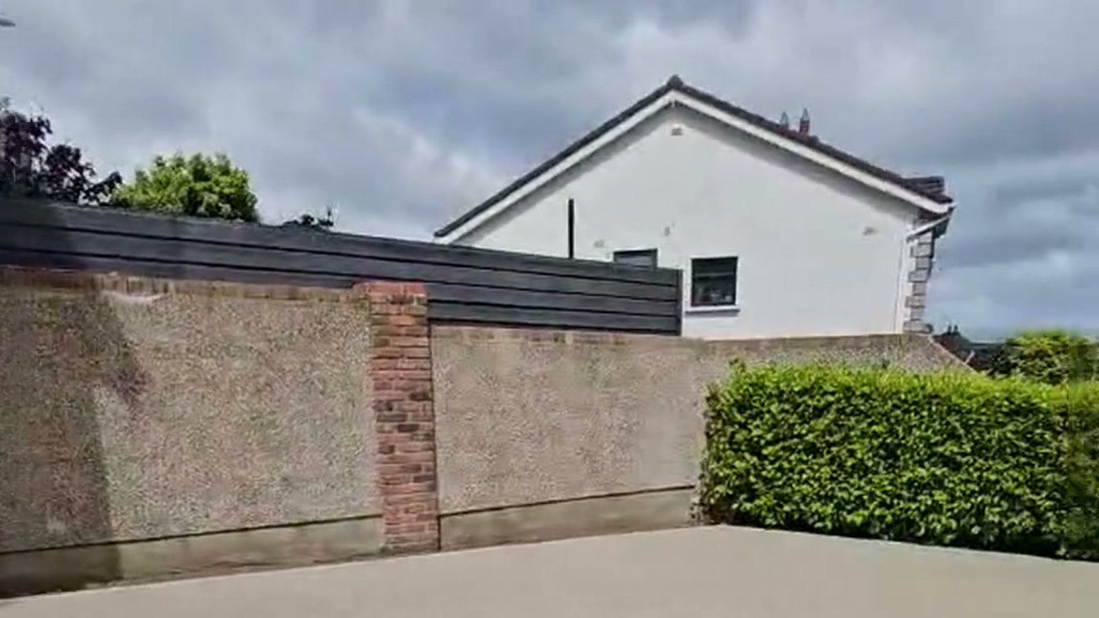 A finished resin bound driveway seen along its granite sett edge